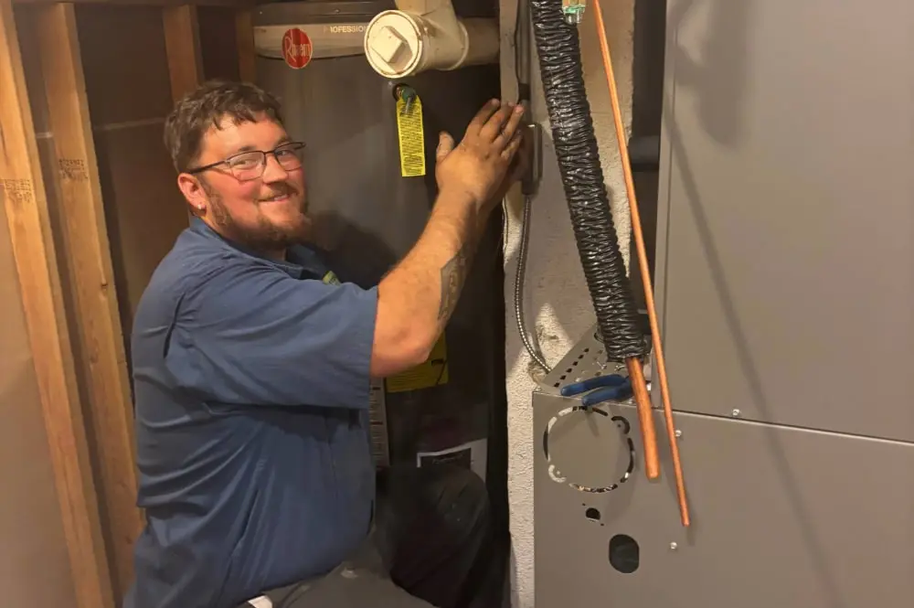 Charter Home Comfort repair technician doing maintenance on a furnace!